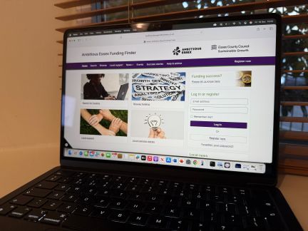 A black laptop showing a website